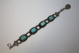 A WHITE METAL SCARAB MOUNTED BRACELET