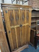 A CARVED OLD CHARM OAK WARDROBE