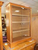 A MODERN GLAZED BOOKCASE