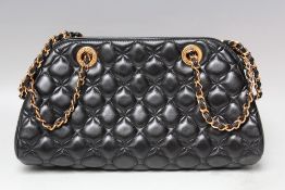 A CHOPARD BLACK QUILTED EVENING BAG, with gold-tone chain and hardware open topped with zipped