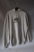 BALENCIAGA, a grey hooded oversized top, labelled as XS but appears much larger