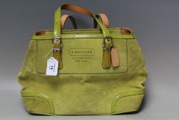 A COACH SUEDE LEATHER HANDBAG, lime green, with twin flat handles and trim, zip and stud
