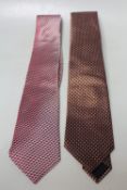 TWO ARMANI COLLEZIONE TRADITIONAL GENTS TIES, comprising one tan and one red patterned examples.