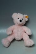 A STEIFF PINK CHILDS TEDDY BEAR, with button and orange tag, H 30 cm