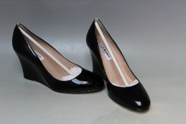 A PAIR OF L.K. BENNETT ESMERALDA PATENT BLACK WEDGE SHOES, size EU 36