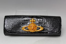 A VIVIENNE WESTWOOD BLACK PATENT CROCODILE EFFECT CLUTCH BAG, with additional gold chain shoulder