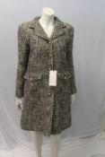 GUCCI, a ladies black and cream coat with gold buttons, size EU 40