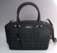 A DKNY BLACK FABRIC REPEAT LOGO DESIGN HANDBAG, gold-tone hardware, detachable shoulder strap, W