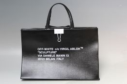 A OFF WHITE SCULPTURE BLACK UNUSUAL HANDBAG, curved textured finish, two loop handles, white clip