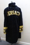 A VERSACE GENTLEMANS BATH ROBE WITH GOLD LETTERING TO THE BACK