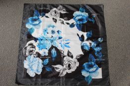 A LADIES 'OFF WHITE' SILKY FABRIC SQUARE SCARF, with rose pattern on white grey and black ground,