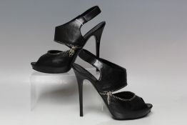A PAIR OF ALEXANDER MCQUEEN STILLETO SLING BACK OPEN TOE BLACK LEATHER SANDALS, with zip detail,