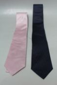 TWO ARMANI COLLEZIONE TRADITIONAL GENTS TIES, comprising one pink and one navy patterned examples.
