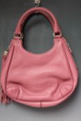 A CHANEL PINK LEATHER HANDBAG, double loop handles, with zip detail and tasselled to the sides, stud