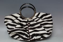 A CHRISTIAN DIOR CALFSKIN ZEBRA EFFECT HAND BAG, with metallic loop hinged handles, with matching