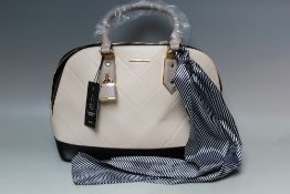AN ALDO CREAM AND BLACK HANDBAG WITH TIED SCARF, zip fastening, W 39 cm