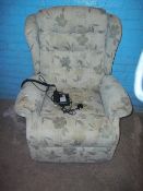 A FABRIC RISE AND RECLINE CHAIR.