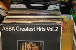 A TUB CONTAINING OVER 70 LP RECORDS INCLUDING ABBA AND THE BEACH BOYS ETC.
