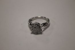 A MODERN 18 CT WHITE GOLD AND DIAMOND CLUSTER RING, APPROX. 0.5 CT WITH FIELDS OF DUBLIN