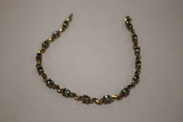 A 9 CT GOLD GREEN STONE BRACELET