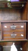 AN EDWARDIAN MINIATURE TWO DRAWER CABINET