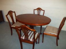 AN OVAL SMALL DINING SET WITH FOUR CHAIRS
