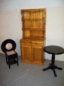 THREE ITEMS: A SOLID PINE DISPLAY WELSH DRESSER WALL UNIT AND TWO BLACK TABLES.