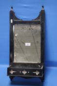 A BLACK PAINTED HANGING WALL MIRROR
