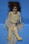 AN ANTIQUE FRENCH BISQUE HEADED DOLL, marked Paris to the back of the head and composition body A/