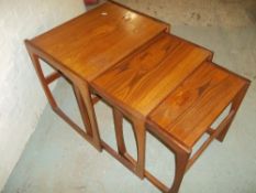 A RETRO TEAK G-PLAN NEST OF THREE TABLES