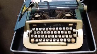 A CASED VINTAGE IMPERIAL TYPEWRITER