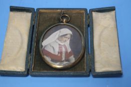A MINIATURE TINTED PHOTOGRAPH OF A WWI NURSE