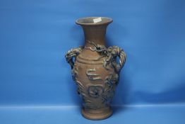A POTTERY TWIN HANDLED VASE