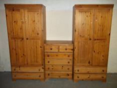 A SOLID PINE THREE PIECE BEDROOM SET TO INCLUDE TWO WARDROBES AND A FOUR + TWO DRAWER CHEST