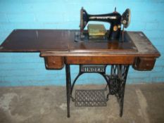AN ANTIQUE SINGER SEWING MACHINE AND TABLE