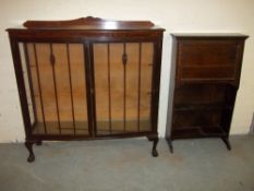 A MAHOGANY CHINA CABINET AND AN OAK NARROW WRITING BUREAU.