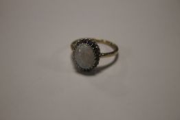 A LADIES 9 CT GOLD AND OPAL DRESS RING