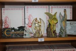 FOUR ENCHANTICA DRAGONS TOGETHER WITH AN ENCHANTICA PLAQUE