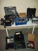 A SELECTION OF POWER TOOLS TO INCLUDE TWO BENCH GRINDERS, A TILE CUTTER AND A HAMMER DRILL.