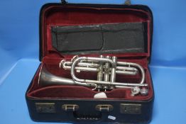 A CASED CONN CORNET WITH MOUTH PIECES
