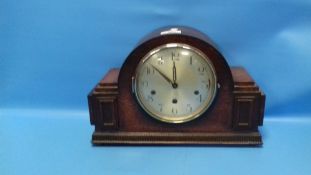 AN OAK MANTEL CLOCK