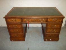 A TWIN PEDESTAL LEATHER INLAID LOCKING DESK