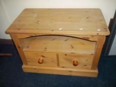 A SOLID HEAVY PINE TV MEDIA CABINET UNIT.