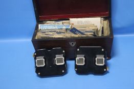 TWO VIEWMASTERS AND SLIDES CONTAINED IN A WOODEN CASKET AND ANOTHER BAKELITE VIEWMASTER