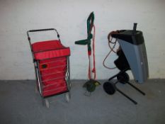 A STRIMMER, SHOPPING TROLLEY AND A TITAN RAPID SHREDDER.