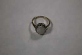 A 9 CT GOLD LADIES RING SET WITH AN OPAL