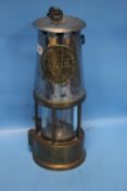 A VINTAGE MINERS LAMP MADE BY THE PROTECTOR LAMP AND LIGHTNING CO. LTD. OF ECCLES, MANCHESTER,