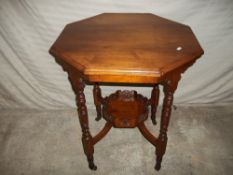 AN EDWARDIAN TWO TIER OCTAGONAL TABLE ON CASTORS