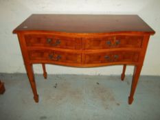 A YEW SERPENTINE FRONTED SIDE TABLE/ DESK WITH 4 LOCKING DRAWERS.