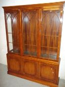 A MODERN THREE DOOR DISPLAY WALL UNIT